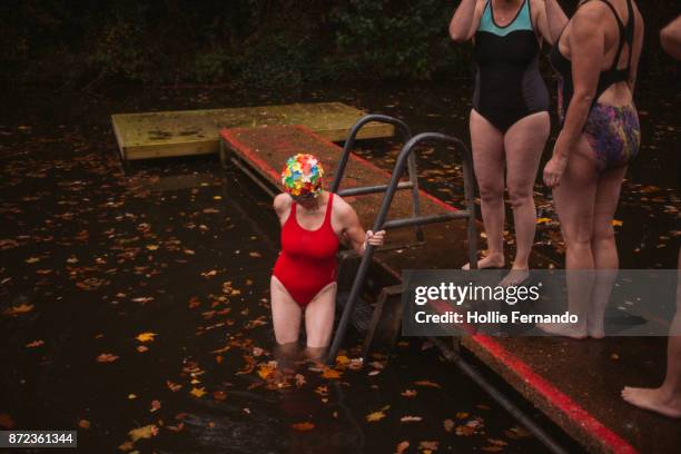 wild swimming women's group autumnal swim - hampstead london stock pictures, royalty-free photos & images