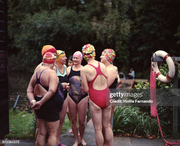 wild swimming women's group autumnal swim - old woman in swimsuit stock pictures, royalty-free photos & images