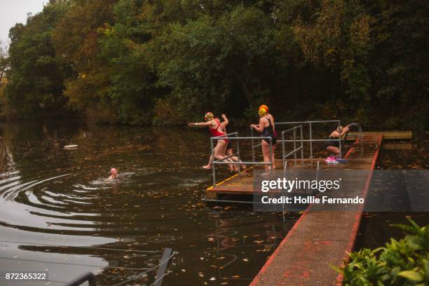 wild swimming women's group autumnal swim - hamstead heath stock pictures, royalty-free photos & images