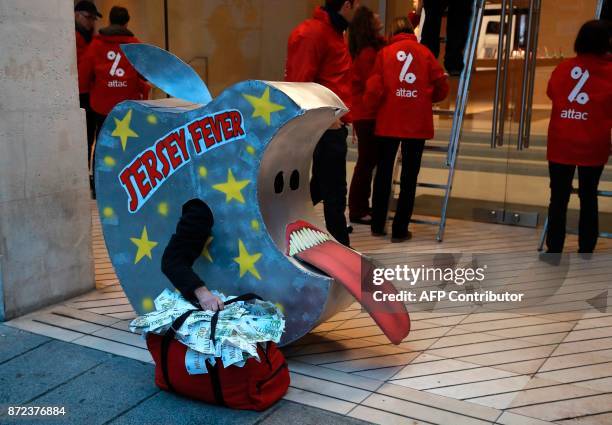 Members of the international Association for the Taxation of financial Transactions and Aid to Citizens , one wearing an apple reading "Jersey...