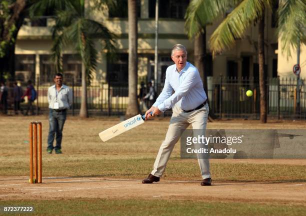 Belgium's King Philippe hits a ball as he plays cricket with children at a ground in Mumbai, India, November 10, 2017.