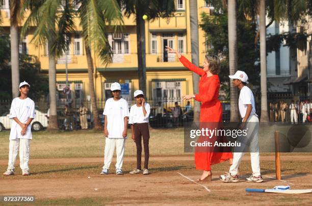 Belgium's Queen Mathilde hits a ball as she plays cricket with children at a ground in Mumbai, India, November 10, 2017.