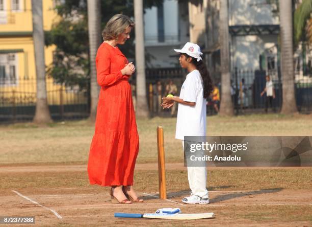 Belgium's Queen Mathilde hits a ball as she plays cricket with children at a ground in Mumbai, India, November 10, 2017.