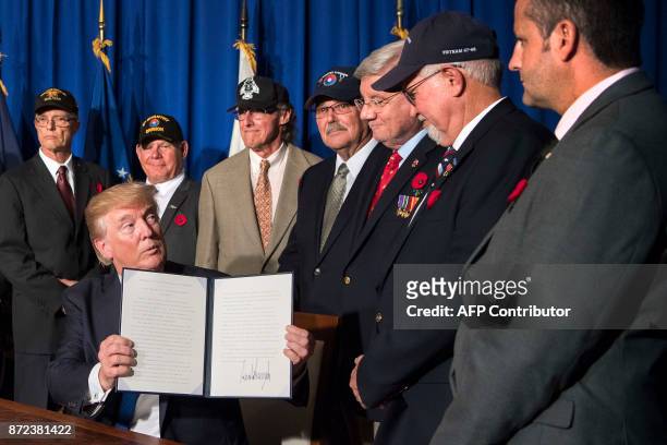 President Donald Trump signs a proclamation in commemoration of the 50th anniversary of the Vietnam War on the sidelines of the Asia-Pacific Economic...