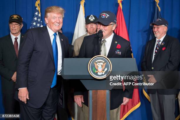 President Donald Trump introduces Vietnam veteran Stave Hopper as he speaks before signing a proclamation in commemoration of the 50th anniversary of...