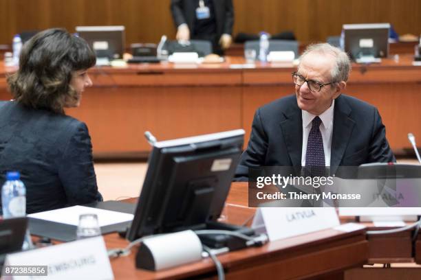 Latvian Finance Minister Dana Reizniece-Ozola talks with the Italian Minister Economy & Finance Pier Carlo Padoan during an EcoFin Ministers meeting...