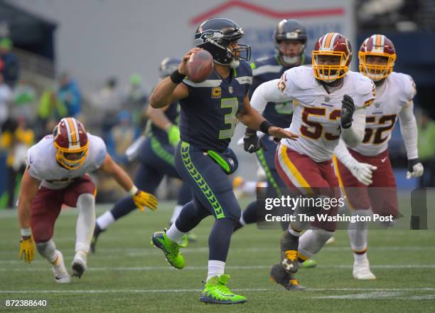 Seattle quarterback Russell Wilson is pressured by Washington inside linebacker Zach Brown , and Washington outside linebacker Ryan Anderson during...