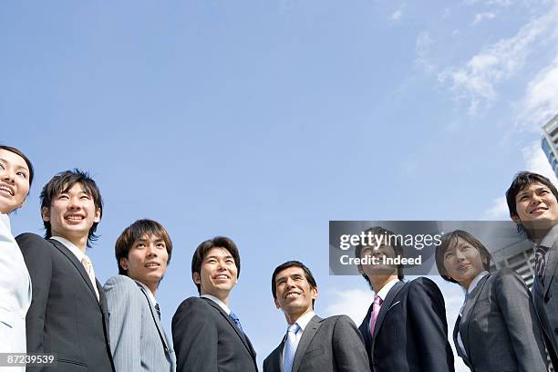 business people standing, low angle view - group of businesspeople standing low angle view stock pictures, royalty-free photos & images