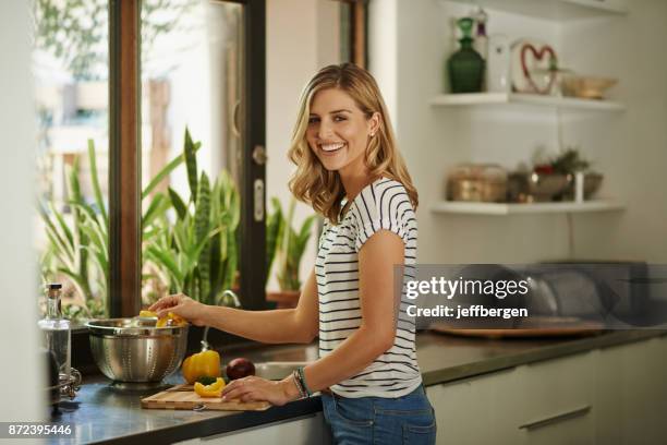 my ingredients are all organic - young woman cooking in kitchen stock pictures, royalty-free photos & images