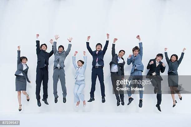 business people jumping and clenching fists - human limb stock pictures, royalty-free photos & images