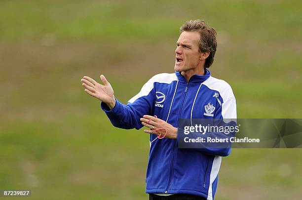 Kangaroos coach Dean Laidley gives instructions to his players during a North Melbourne Kangaroos AFL training session at Arden Street Oval on May...