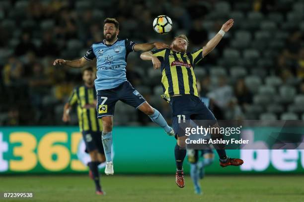Michael Zullo of Sydney FC contests the ball against Connor Pain of the Mariners during the round six A-League match between the Central Coast...