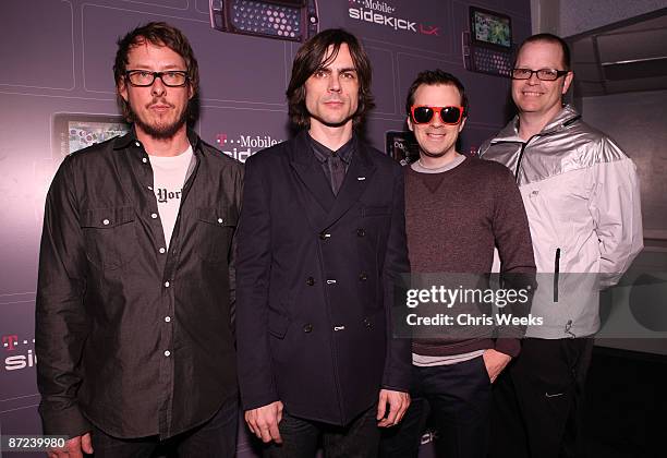 Musicians Scott Shriner, Brian Bell, Rivers Cuomo and Patrick Wilson of Weezer pose backstage at the T-Mobile Sidekick LX launch event at Paramount...