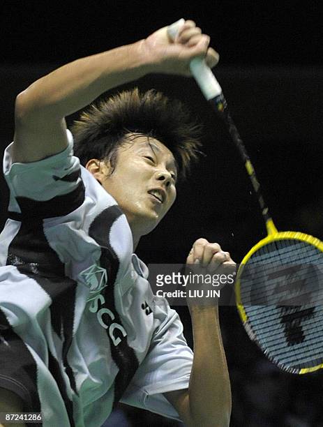 Thailand's Boonsak Ponsana returns a shuttlecock to Russia's Stanislav Pukhov during the men's singles play-off match at the Sudirman Cup world team...