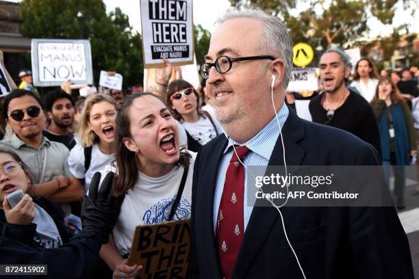 Protesters heckle people attending a Liberal Party fundraiser in Sydney on November 10 as they call on the ruling Liberal coalition government to...