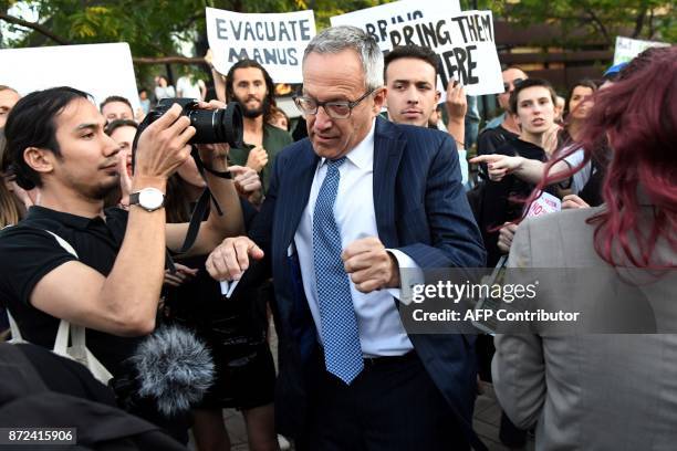 Protesters jostle people attending a Liberal Party fundraiser in Sydney on November 10 as they call on the ruling Liberal coalition government to...