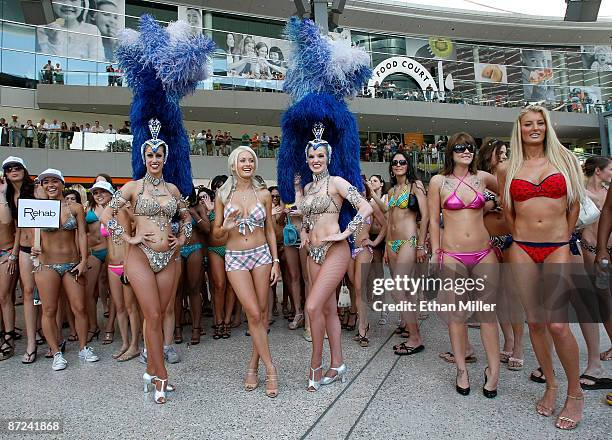 Model and television personality Holly Madison, flanked by "Jubilee!" showgirls Deana Dakake and Amanda Portie, pose after helping the Las Vegas...