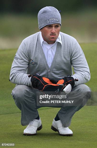 Northern Irish golfer Graeme McDowell lines up a putt on the 11th green during the 1st round of the Irish Open at Baltray in County Louth, in...