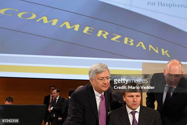 Martin Blessing , CEO of the Commerzbank AG, Peter Mueller , head of the supervisory board and board member Eric Strutz look on at the annual...