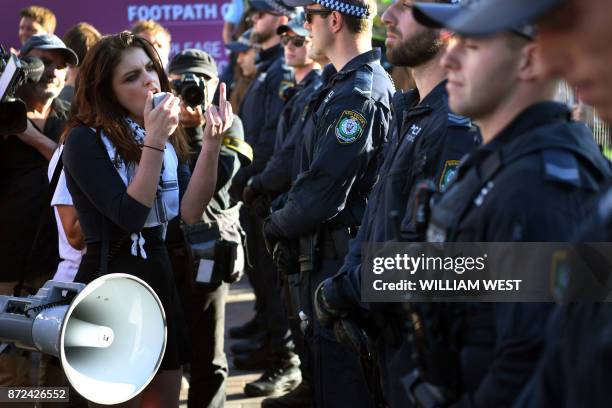 Protesters chant at a Liberal Party fundraiser in Sydney on November 10 as they call on the ruling Liberal coalition government to bring back 600...