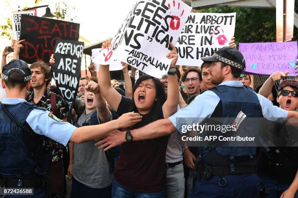 Protesters chant at a Liberal Party fundraiser in Sydney on November 10 as they call on the ruling Liberal coalition government to bring back 600...