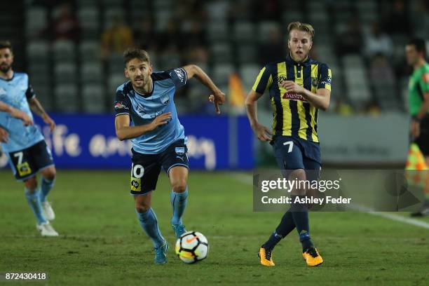 Andrew Hoole of the Mariners contests the ball against Milos Ninkovic of Sydney FC during the round six A-League match between the Central Coast...