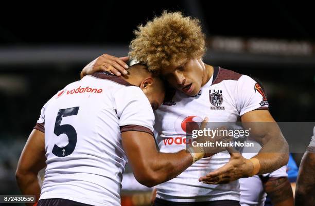 Marcelo Montoya of Fiji is congratulated by team mate Eloni Vunakece after scoring during the 2017 Rugby League World Cup match between Fiji and...