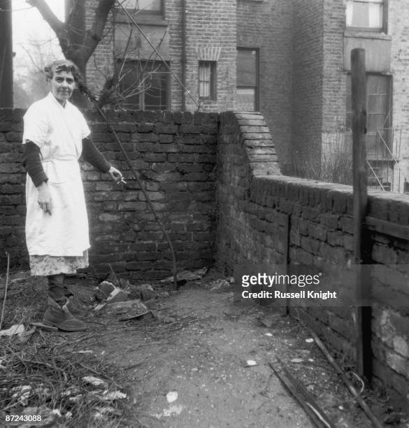 Mrs Hart, the neighbour of serial killer John Reginald Christie, points to the spot in the garden of 10 Rillington Place, London, where two of his...