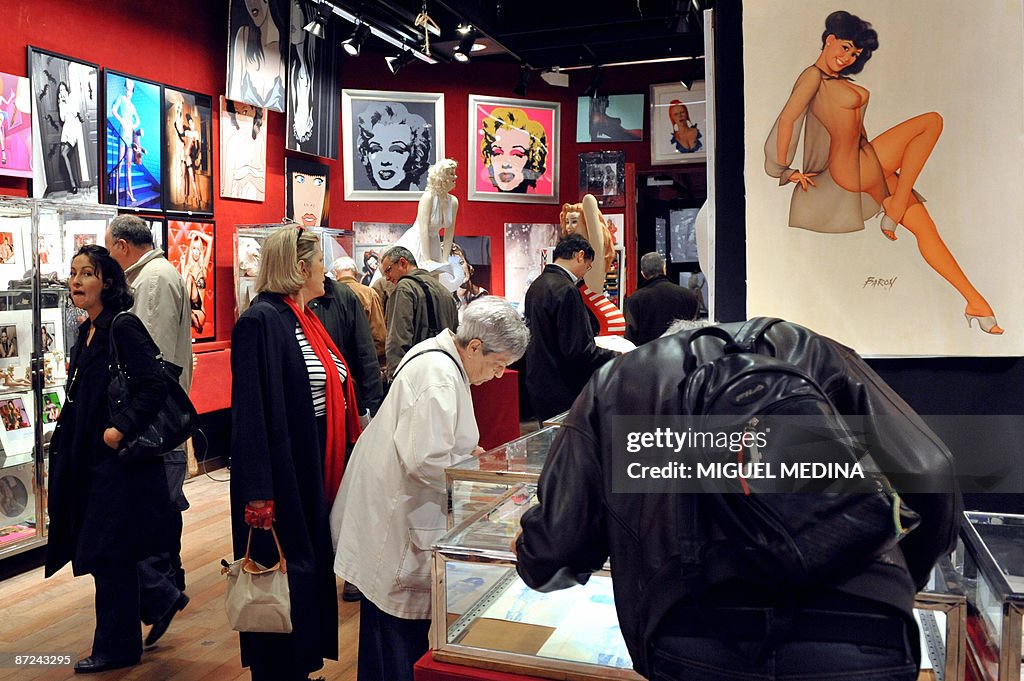 People look at works exhibited on the ev