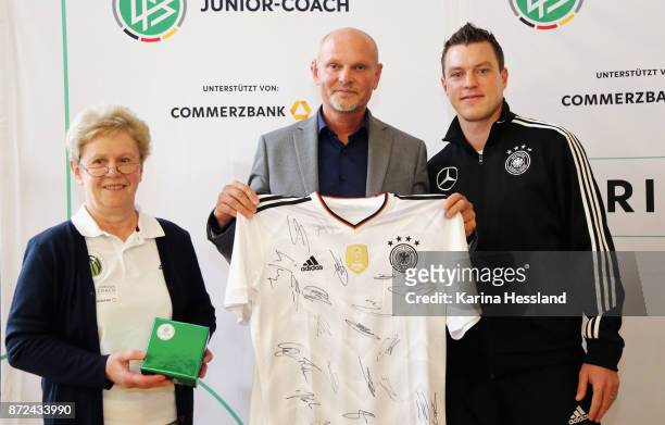 Dr. Ulrike Hauser, Principal Ralf Ballmann and Coach Hanno Balitsch of DFB U20 with a original Shirt by the Nationalteam of Germany with all Players...