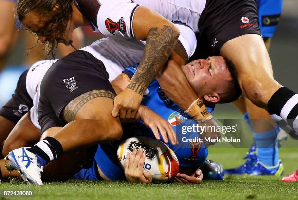 Nathan Brown of Italy is tackled high during the 2017 Rugby League World Cup match between Fiji and Italy at Canberra Stadium on November 10, 2017 in...