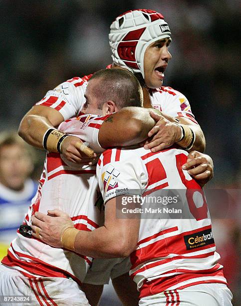 Jamie Soward, Neville Costigan and Justin Poore of the Dragons celebrate a try by Poore during the round 10 NRL match between the St George Illawarra...