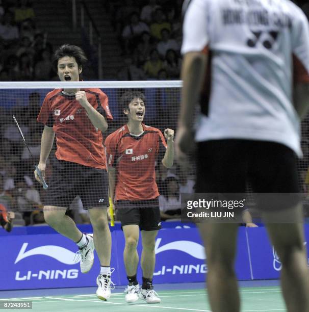 Japan's Kenichi Hayakawa and his teammate Kenta Kazuno react to a winning point against Hong Kong's Hui Wai Ho and Albertus Susanto Njoto during the...