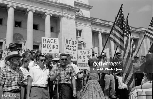 View of perticipants in an anti-integration rally on the steps of the Arkansas State Capitol, Little Rock, Arkansas, August 20, 1959. Several carry...