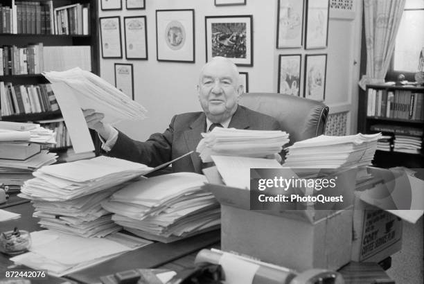Portrait of American politician US Senator Sam Ervin as he sits behind his desk which is covered in piles of letters, Washington DC, February 8,...