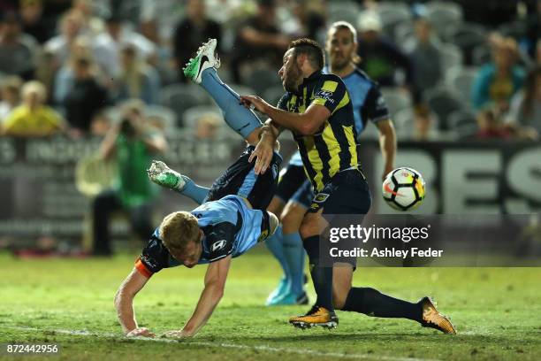 Josh Rose of the Mariners contests the ball against Matt Simon of Sydney FC during the round six A-League match between the Central Coast Mariners...