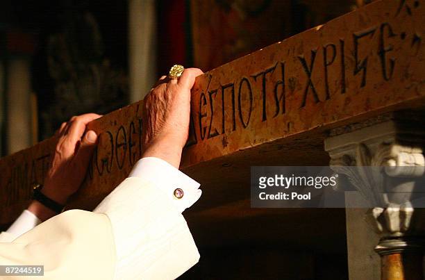 Pope Benedict XVI touches the traditional site where Jesus was crucified in the Golgotha, or Calvary, in the Church of the Holy Sepulchre on May 15,...