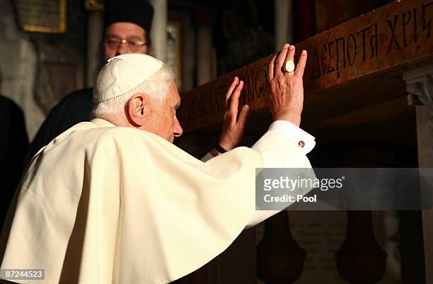 Pope Benedict XVI touches the traditional site where Jesus was crucified in the Golgotha, or Calvary, in the Church of the Holy Sepulchre on May 15,...