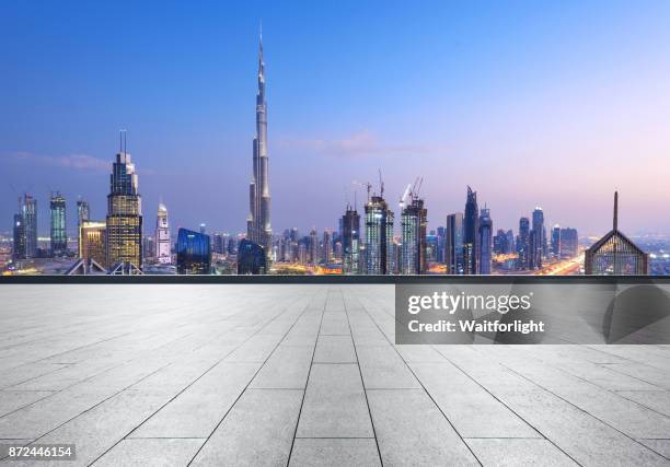 empty car parking with dubai downtown background - burj khalifa stock-fotos und bilder