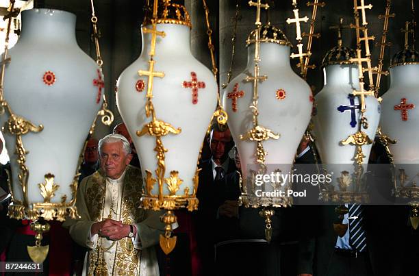 Pope Benedict XVI stands in front of the Stone of Anointing, where Christians believe the body of Jesus was prepared for burial, in the Church of the...