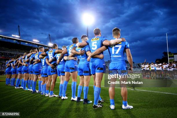 The Italian team watch on as the Fijian side sing a hym before the 2017 Rugby League World Cup match between Fiji and Italy at Canberra Stadium on...