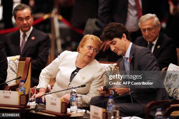 Canad's Prime Minister Justin Trudeau and Chile's President Michelle Bachelet talk during the APEC-ASEAN dialogue on the sidelines of the...