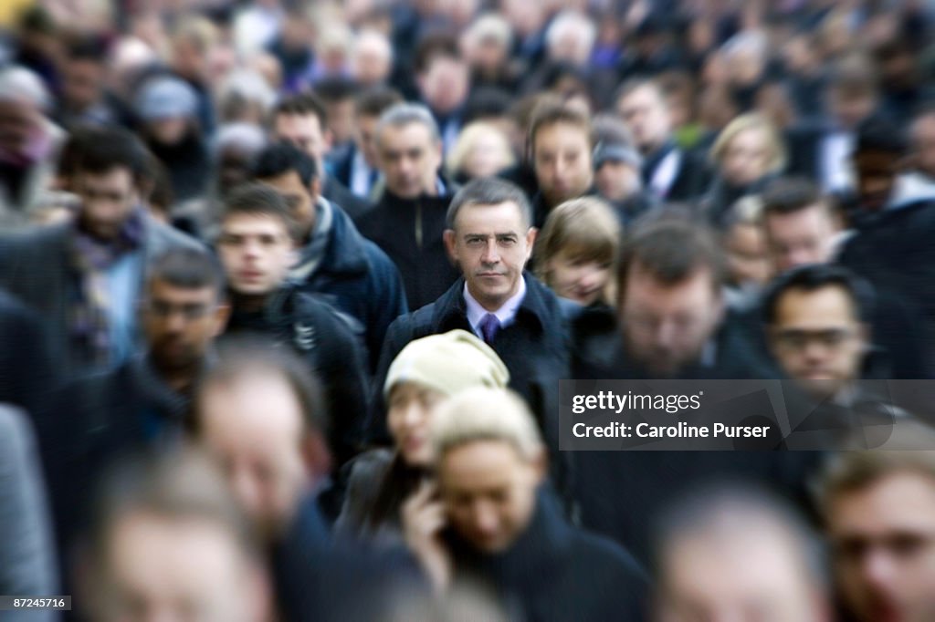 Blurred commuters with one man in focus