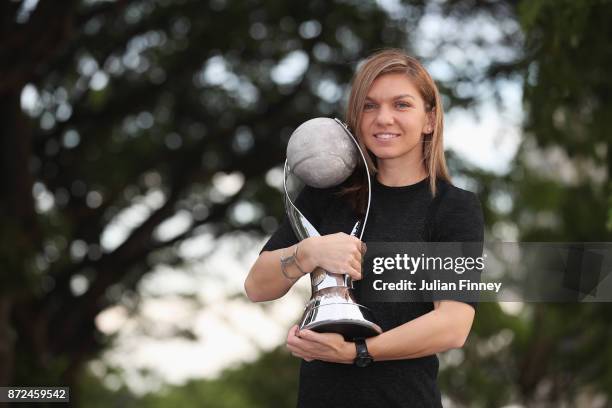 Simona Halep of Romania poses with the WTA World No.1 trophy during day 7 of the BNP Paribas WTA Finals Singapore presented by SC Global at Singapore...