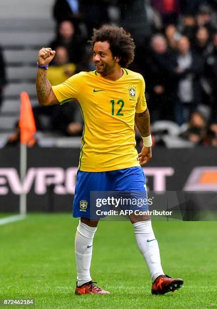 Brazil's defender Marcelo reacts after scoring a goal during the friendly football match between Brasil and Japan at the Pierre-Mauroy Stadium in...