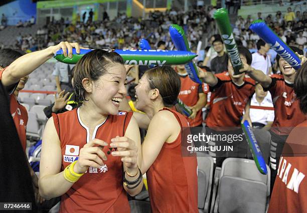 Japan's Miyuki Maeda and Satoko Suetsuna celebrate with teammates after winning over Hong Kong's Wang Chen and Zhou Mi during the women's doubles...
