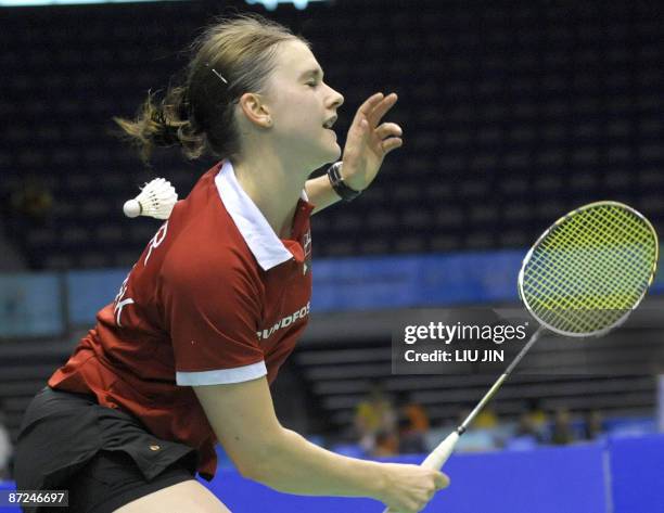 Denmark's Lena Frier Kristiansen is hit by a shuttlecock during the women's doubles play-off match against Britain's Jennifer Wallwork and Donna...