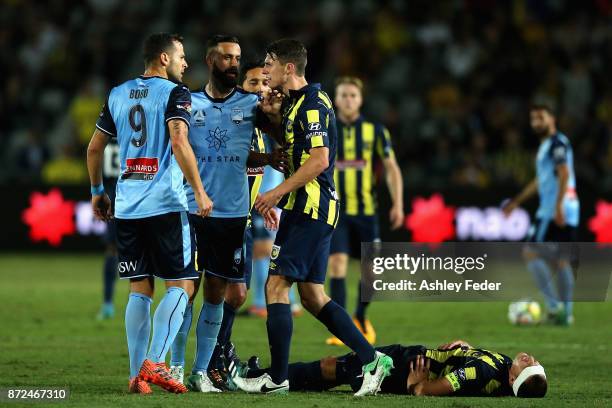 Bobo and Alex Brosque of Sydney FC have an altercation with Jake McGing of the Mariners with Alan Baro of the Mariners lying on the ground during the...