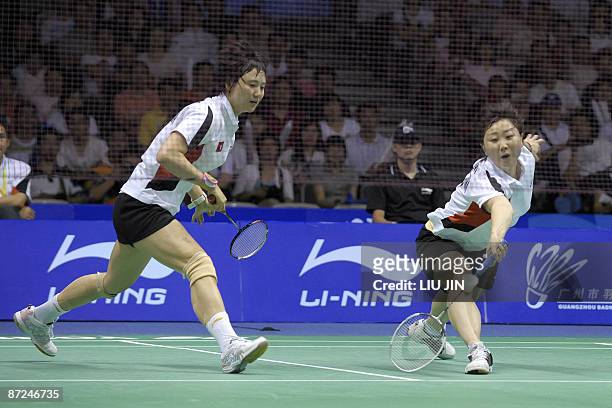 Hong Kong's Zhou Mi and her teammate Wang Chen compete against Japan's Miyuki Maeda and Satoko Suetsuna during the women's doubles play-off match at...