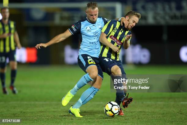 Connor Pain of the Mariners contests the ball with Jordy Buijs of Sydney FC during the round six A-League match between the Central Coast Mariners...